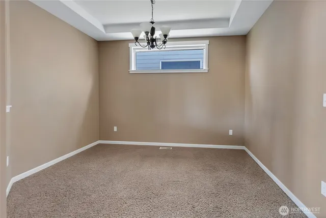 a view of an empty room with a chandelier