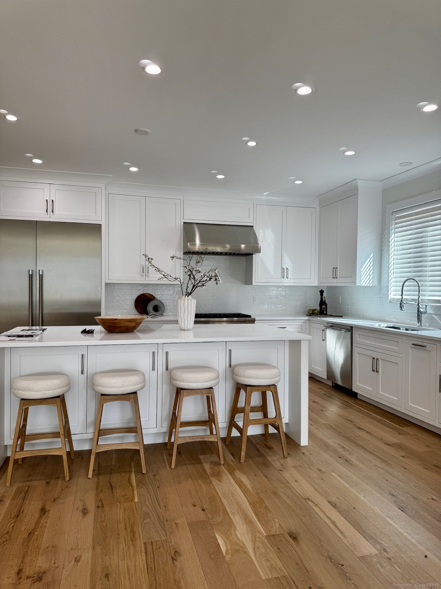 a kitchen with a sink cabinets and wooden floor