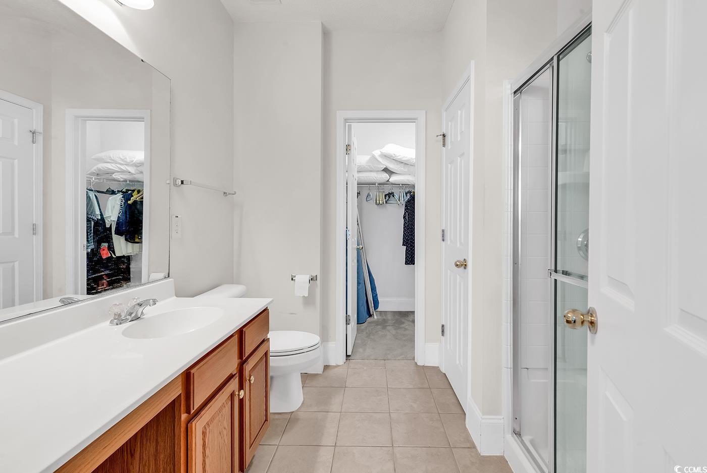 101 Culpepper Way, Unit 1006 Myrtle Beach, SC 29579 - Photo 13 of 40 Full bathroom featuring a shower stall, tile patterned floors, vanity, and toilet