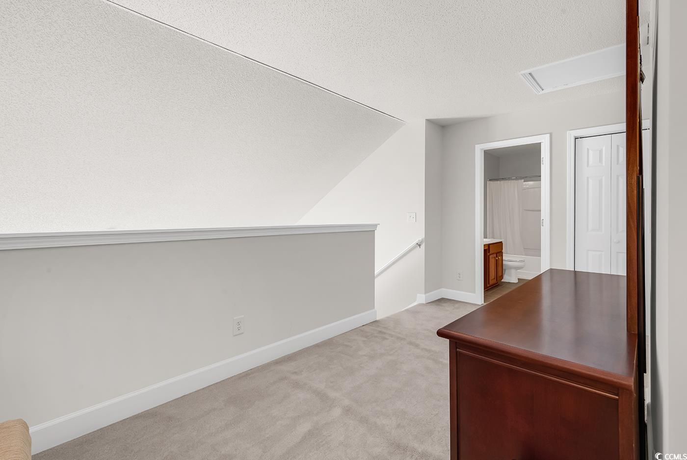 101 Culpepper Way, Unit 1006 Myrtle Beach, SC 29579 - Photo 16 of 40 Upstairs, light colored carpet, a textured ceiling, and baseboards