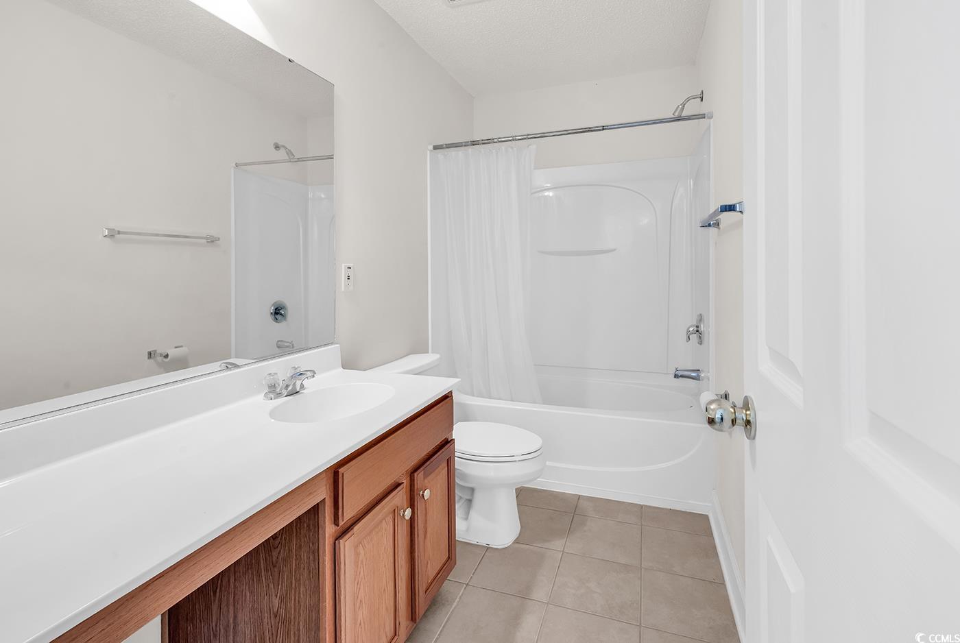101 Culpepper Way, Unit 1006 Myrtle Beach, SC 29579 - Photo 20 of 40 Bathroom featuring tile patterned flooring, vanity, shower / bath combination with curtain, and toilet