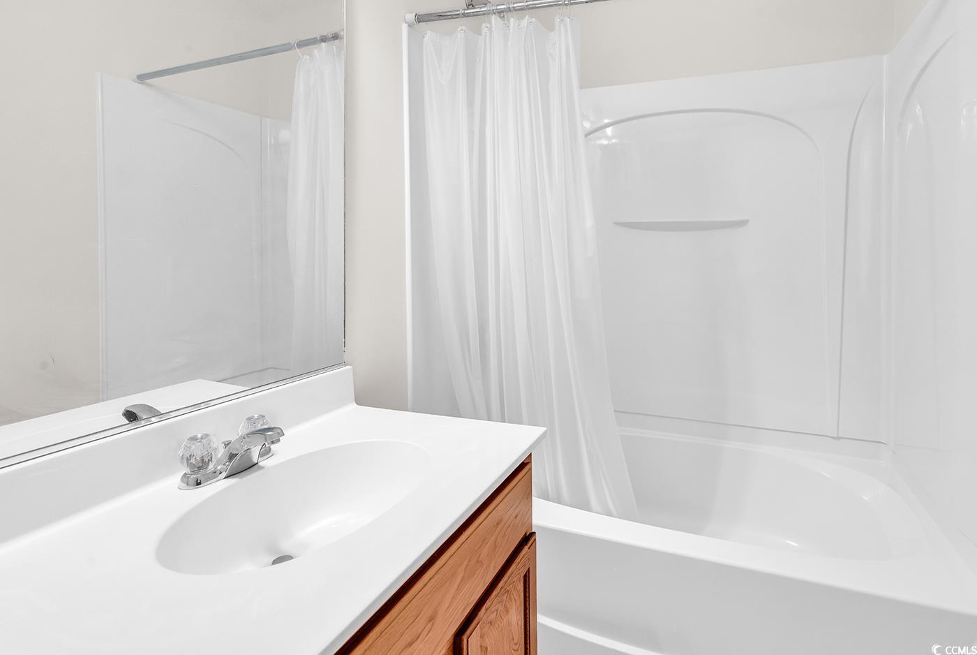 101 Culpepper Way, Unit 1006 Myrtle Beach, SC 29579 - Photo 23 of 40 Bathroom featuring vanity and shower / bath combination with curtain