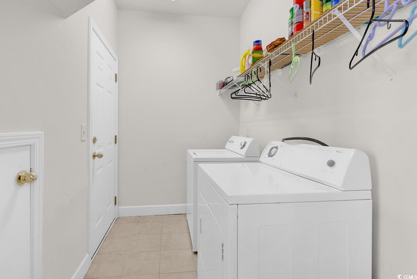 101 Culpepper Way, Unit 1006 Myrtle Beach, SC 29579 - Photo 24 of 40 Washroom with washing machine and clothes dryer, baseboards, and light tile patterned flooring