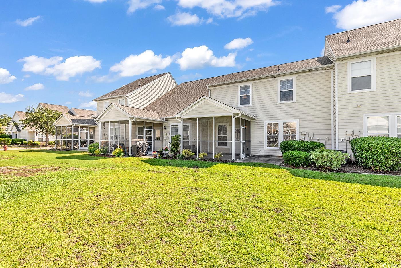 101 Culpepper Way, Unit 1006 Myrtle Beach, SC 29579 - Photo 28 of 40 Back of house with a sunroom and a lawn