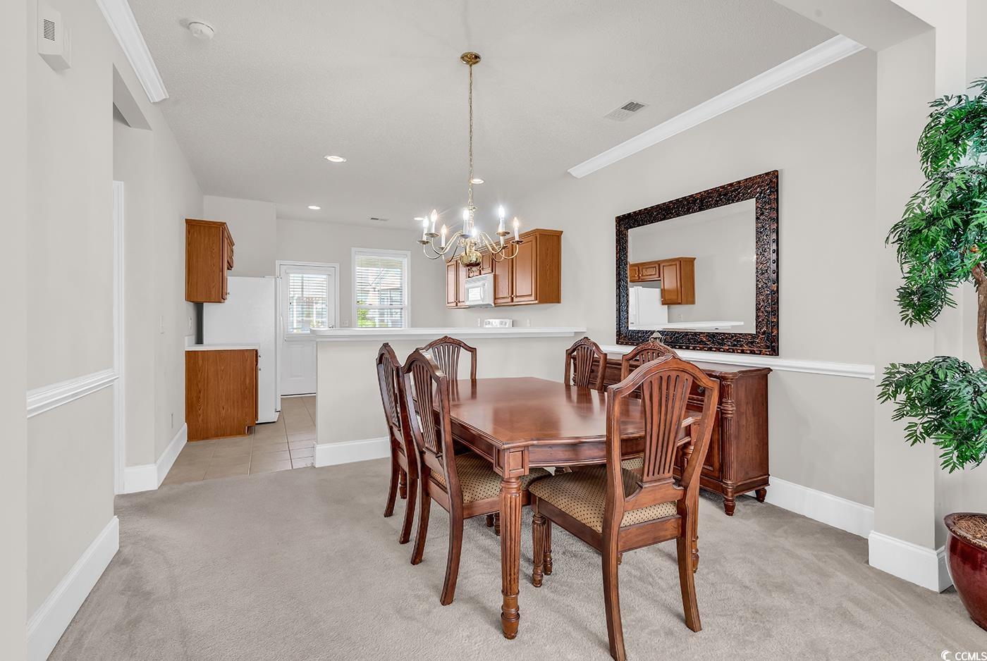 101 Culpepper Way, Unit 1006 Myrtle Beach, SC 29579 - Photo 6 of 40 Dining space featuring a chandelier, light colored carpet, ornamental molding, baseboards, and recessed lighting
