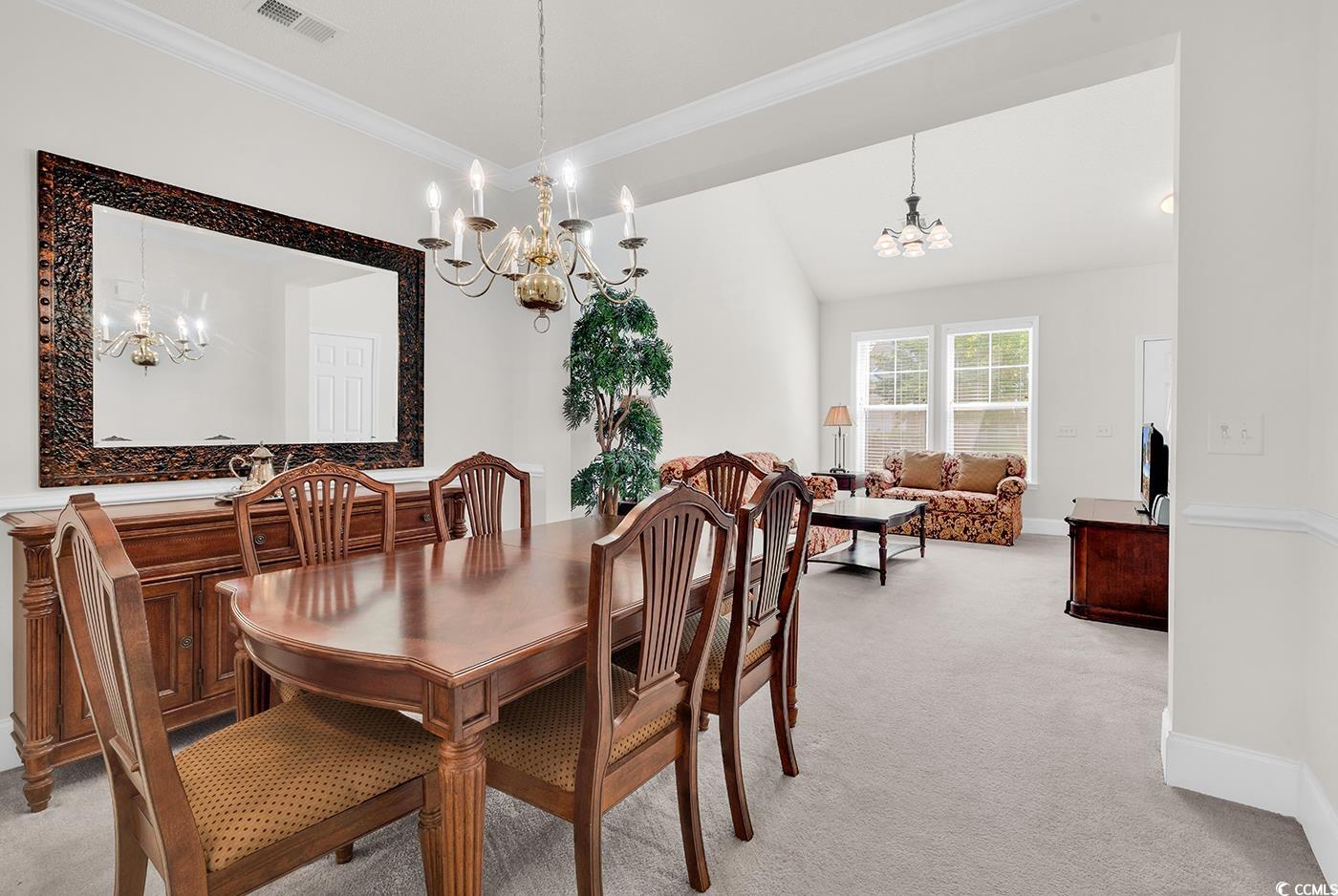 101 Culpepper Way, Unit 1006 Myrtle Beach, SC 29579 - Photo 7 of 40 Dining space featuring a chandelier, light colored carpet, ornamental molding, and baseboards