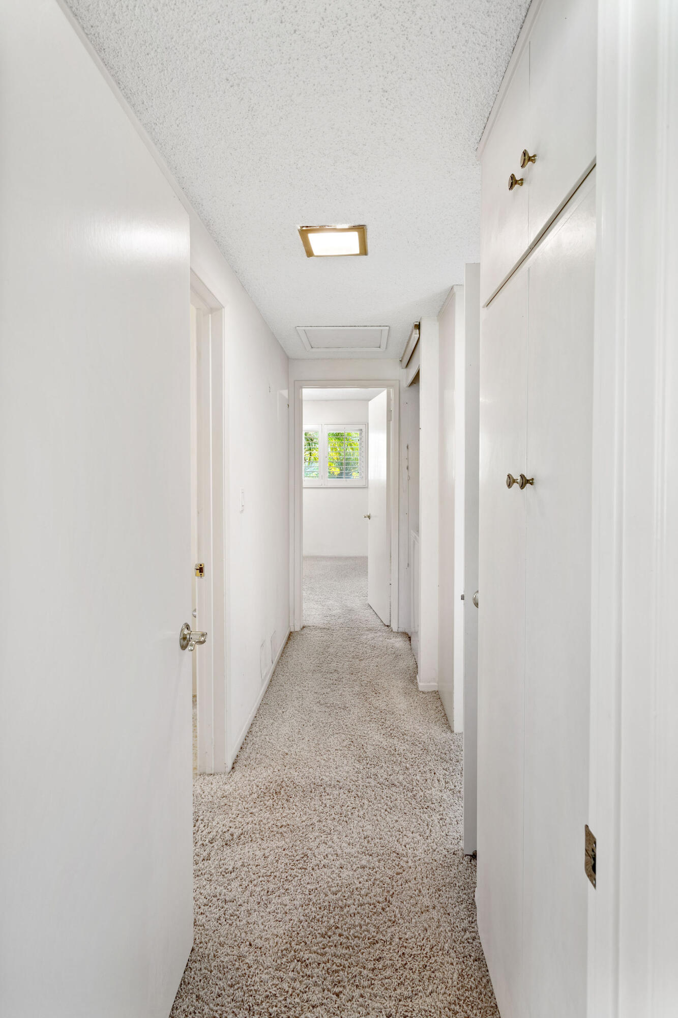 5822 Encina Road, Unit 2 Santa Barbara, CA 93117 - Photo 17 of 42 a view of a hallway with wooden shelves