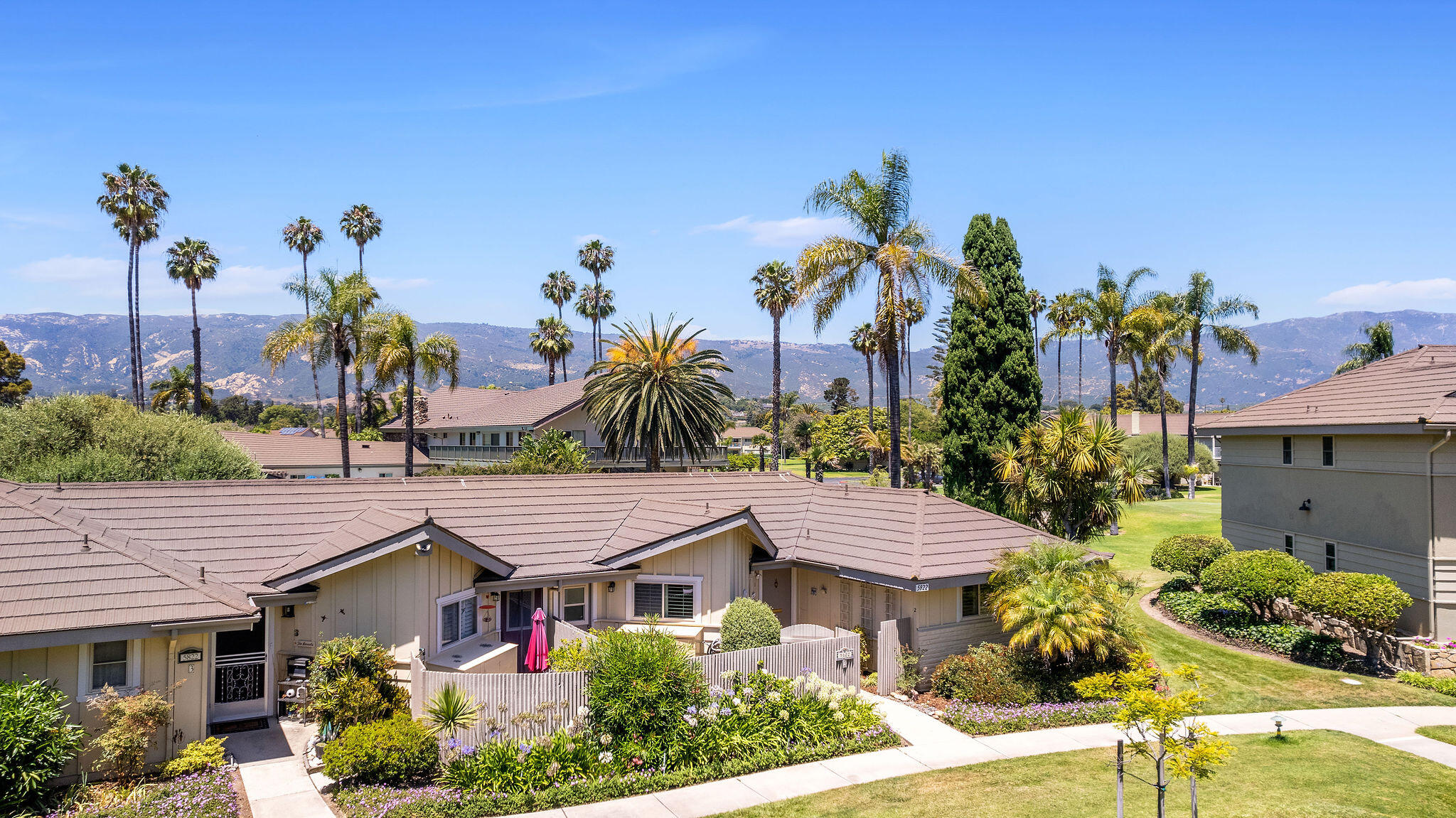 5822 Encina Road, Unit 2 Santa Barbara, CA 93117 - Photo 23 of 42 a front view of a house with a yard and potted plants