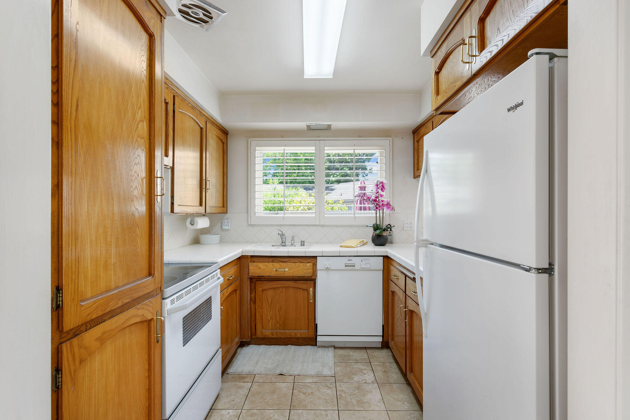 5822 Encina Road, Unit 2 Santa Barbara, CA 93117 - Photo 3 of 42 a kitchen with a sink a refrigerator a washer and dryer