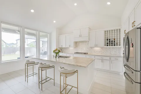 a spacious bathroom with a double vanity sink mirror and a bathtub