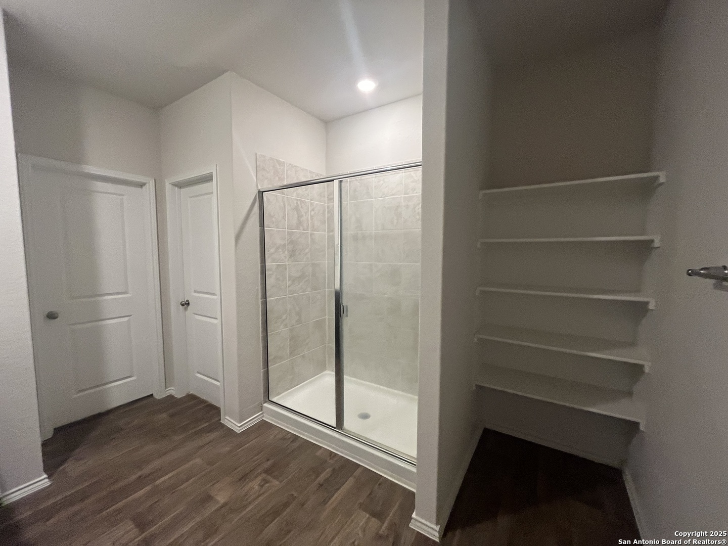 141 Middle Grn Loop Floresville, TX 78114 - Photo 13 of 29 a view of an empty room with wooden floor and a window