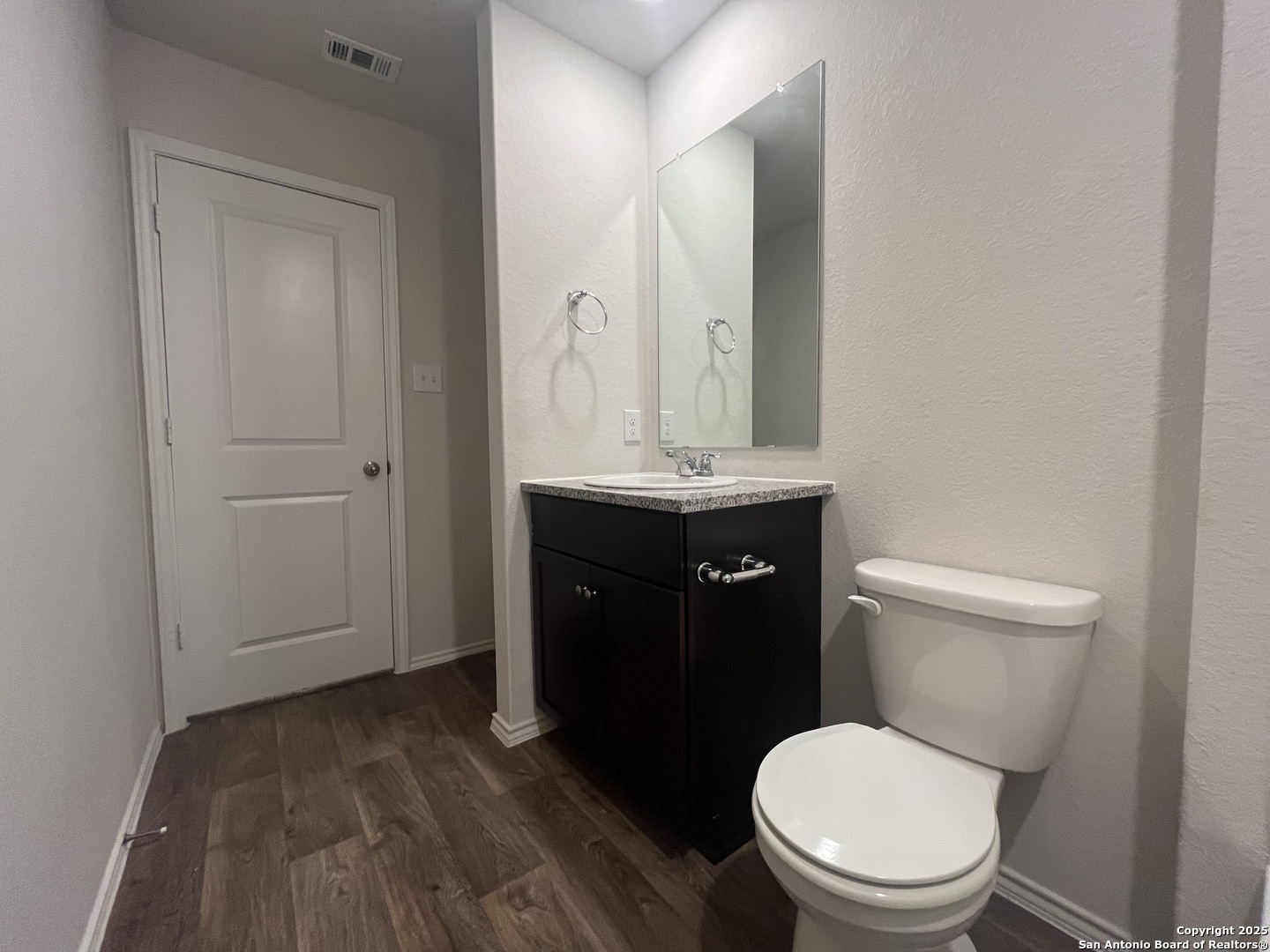 141 Middle Grn Loop Floresville, TX 78114 - Photo 29 of 29 a bathroom with a toilet a sink and mirror