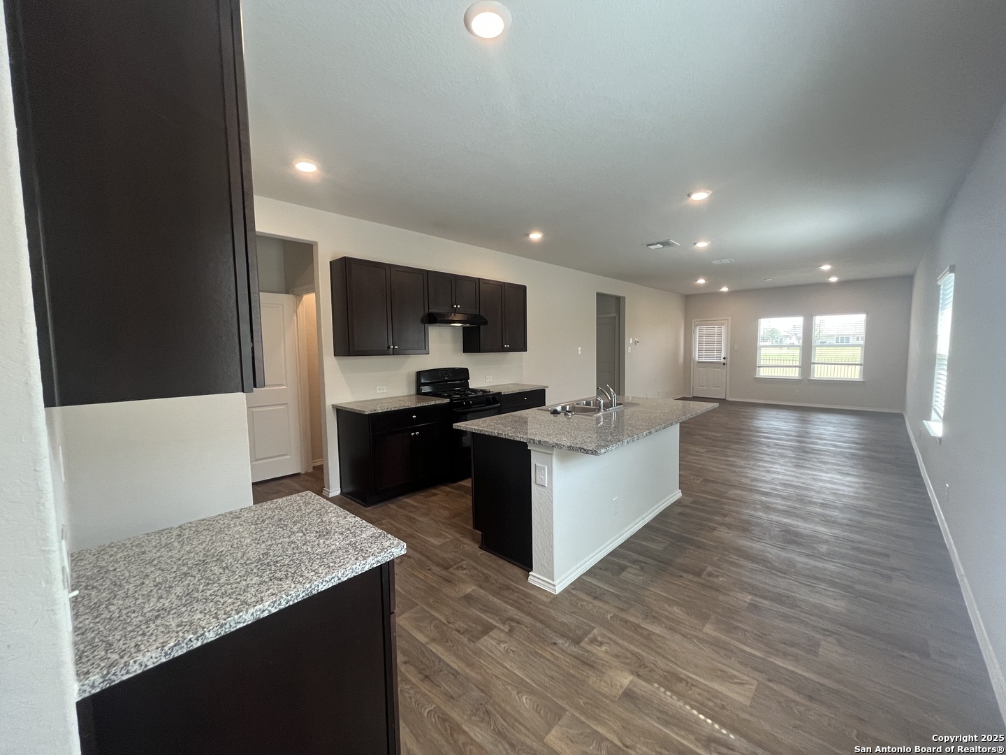 141 Middle Grn Loop Floresville, TX 78114 - Photo 3 of 29 a large kitchen with a center island and stainless steel appliances