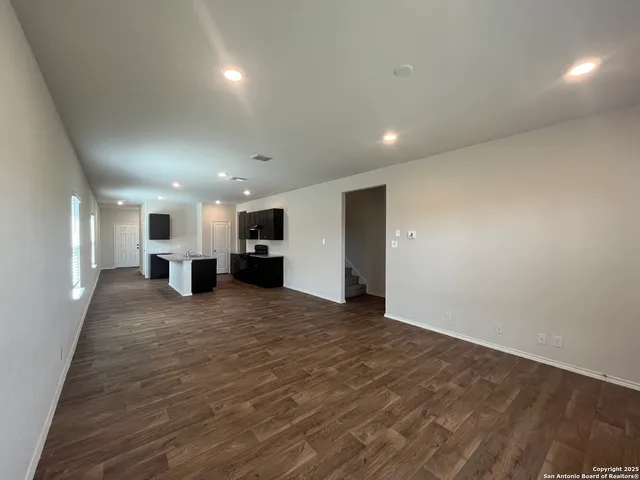 a view of kitchen and a refrigerator in a hall