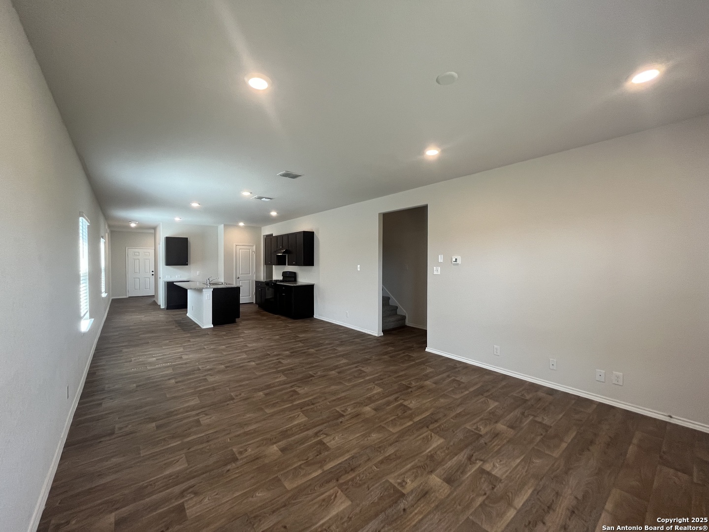 141 Middle Grn Loop Floresville, TX 78114 - Photo 6 of 29 a view of kitchen and a refrigerator in a hall