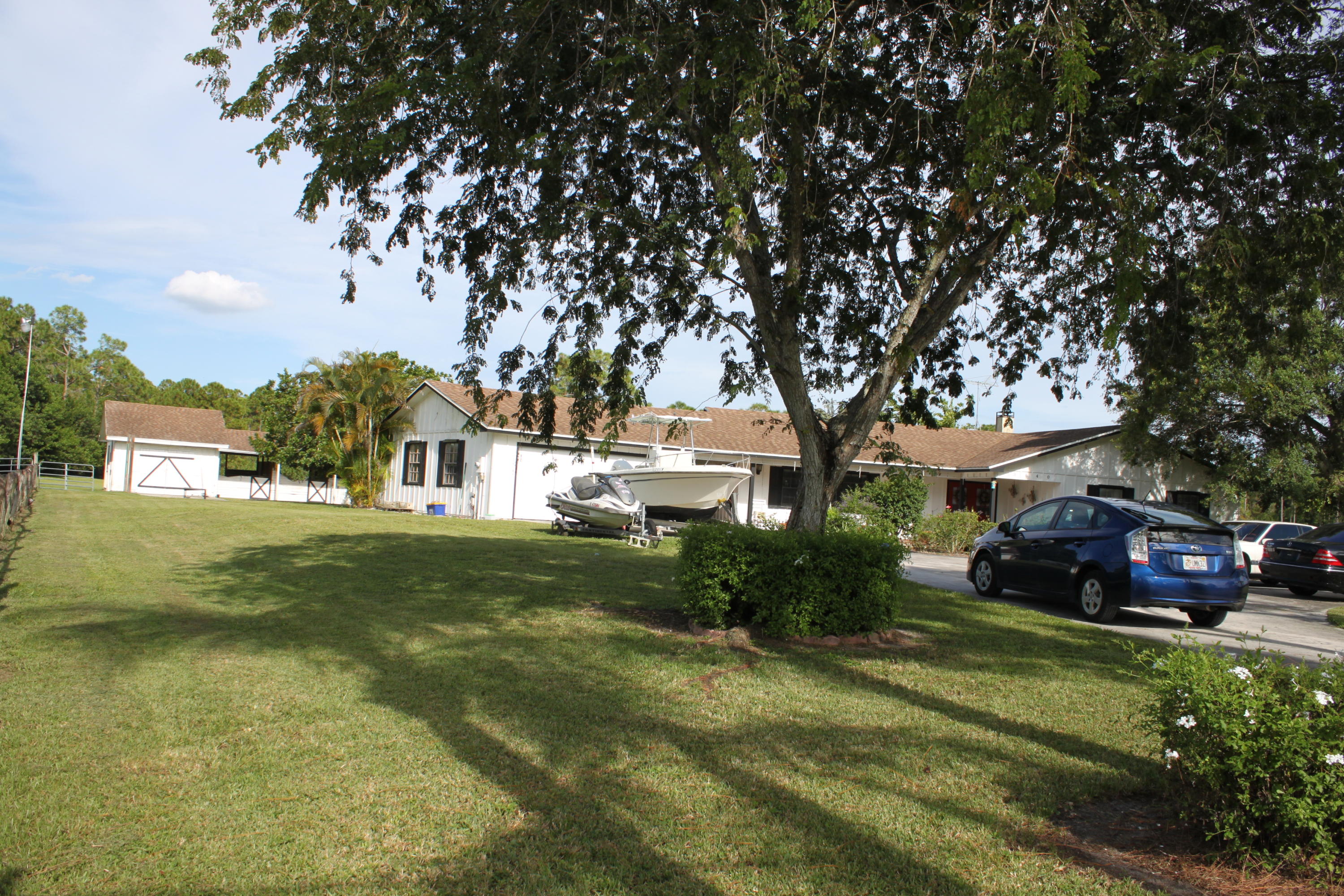 3840 Dellwood Road Loxahatchee, FL 33470 - Photo 15 of 60 a front view of a house with a garden