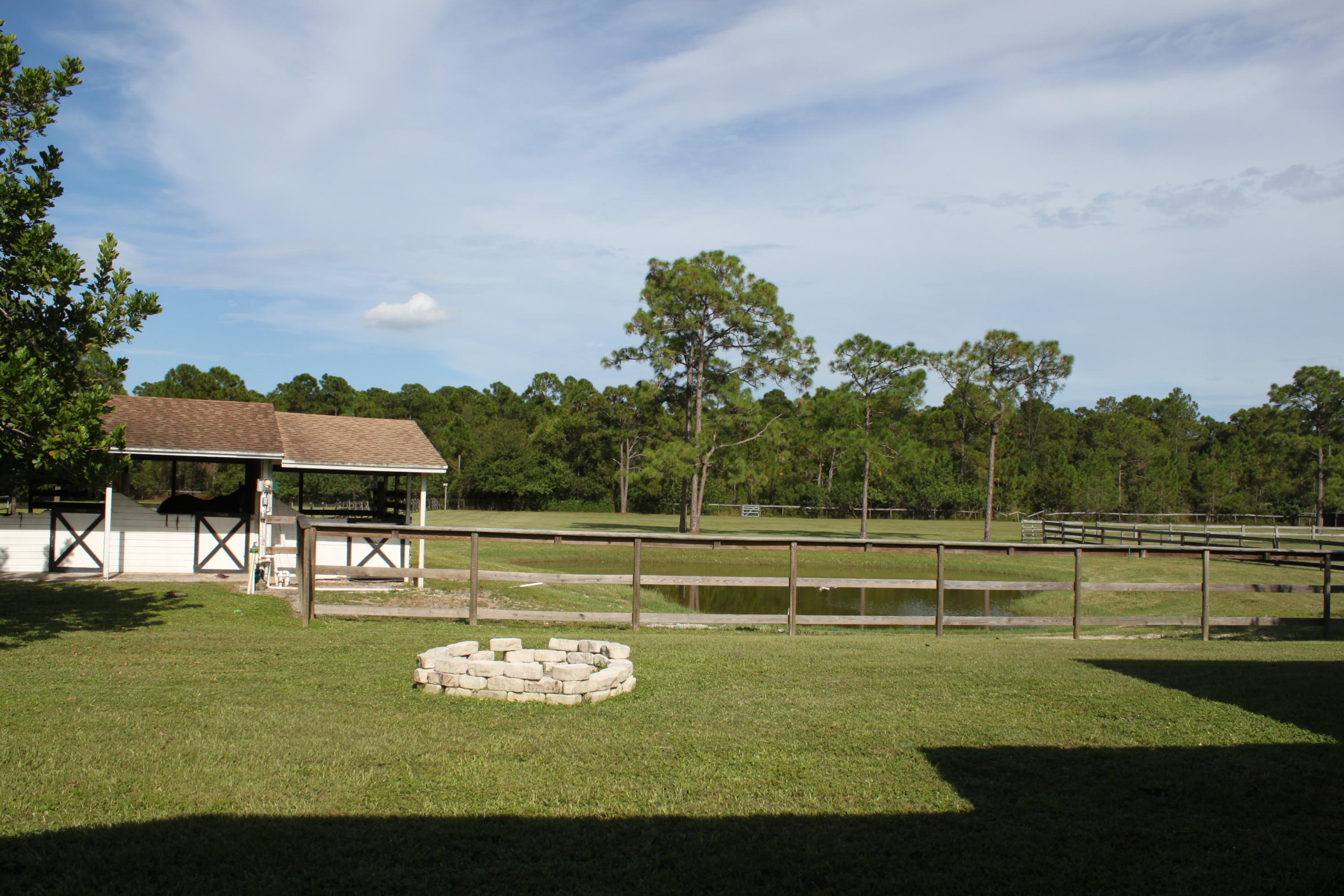 3840 Dellwood Road Loxahatchee, FL 33470 - Photo 16 of 60 a view of a swimming pool with a garden