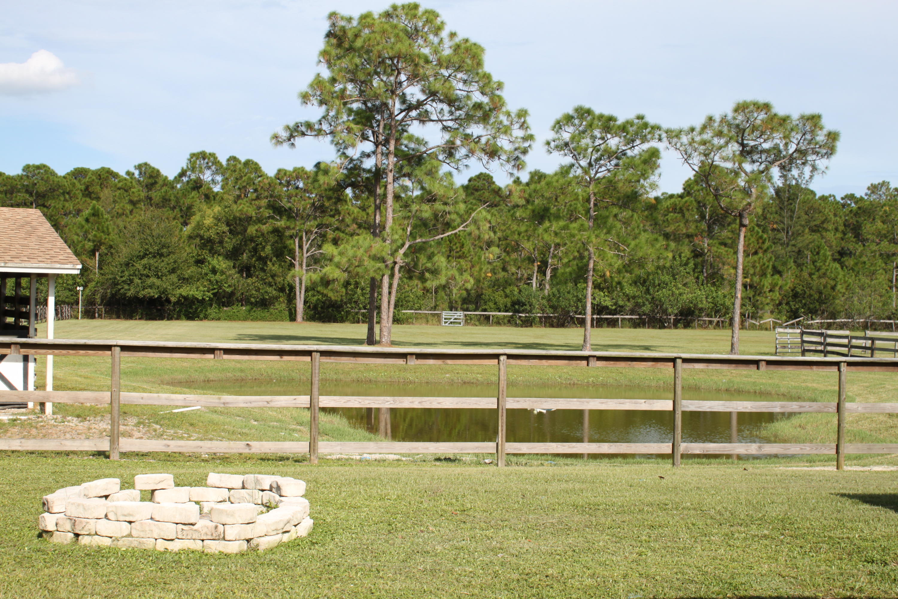 3840 Dellwood Road Loxahatchee, FL 33470 - Photo 20 of 60 a view of a swimming pool with an outdoor space and seating area