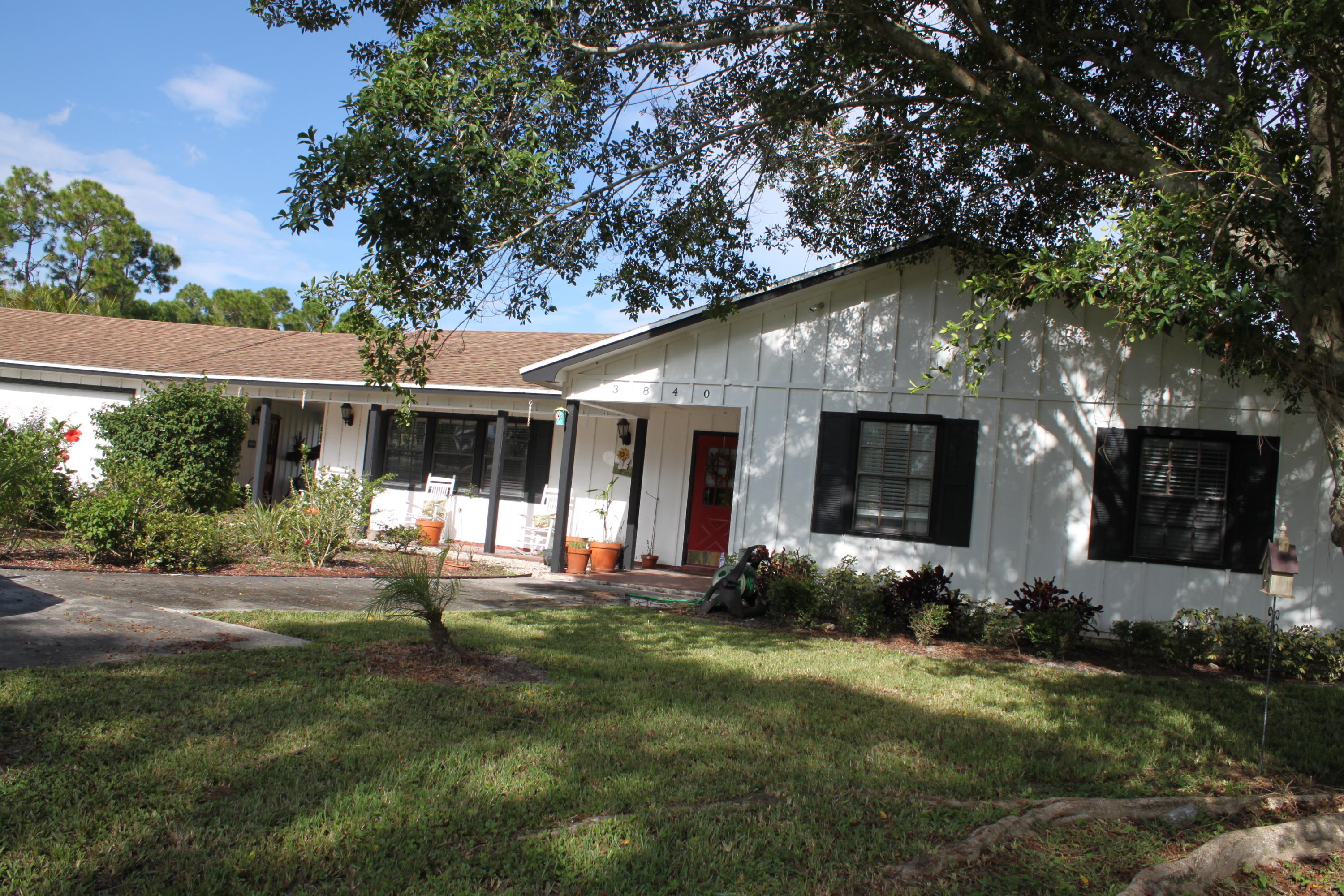 3840 Dellwood Road Loxahatchee, FL 33470 - Photo 2 of 60 a front view of house with a garden and patio