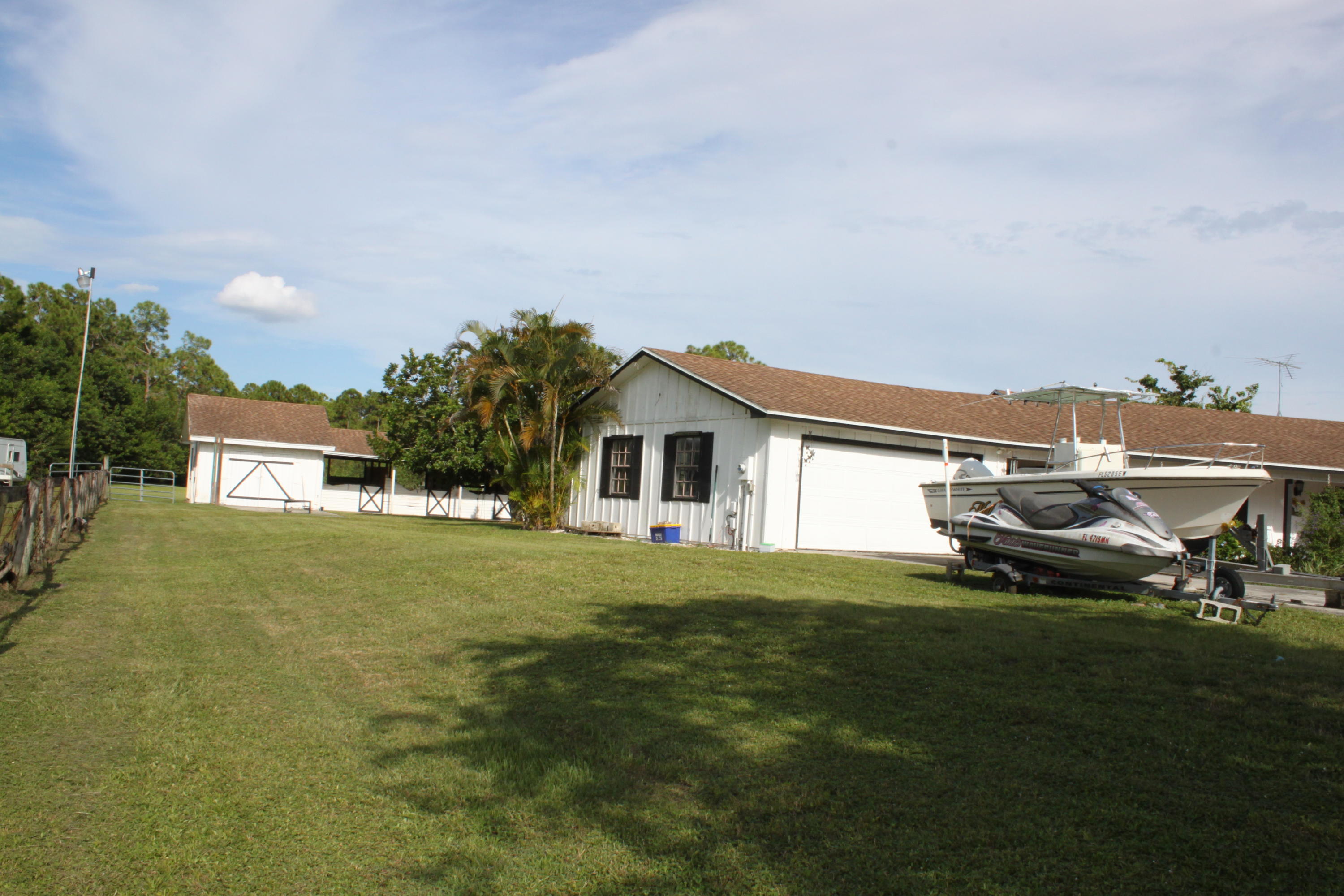 3840 Dellwood Road Loxahatchee, FL 33470 - Photo 21 of 60 a house view with a garden space