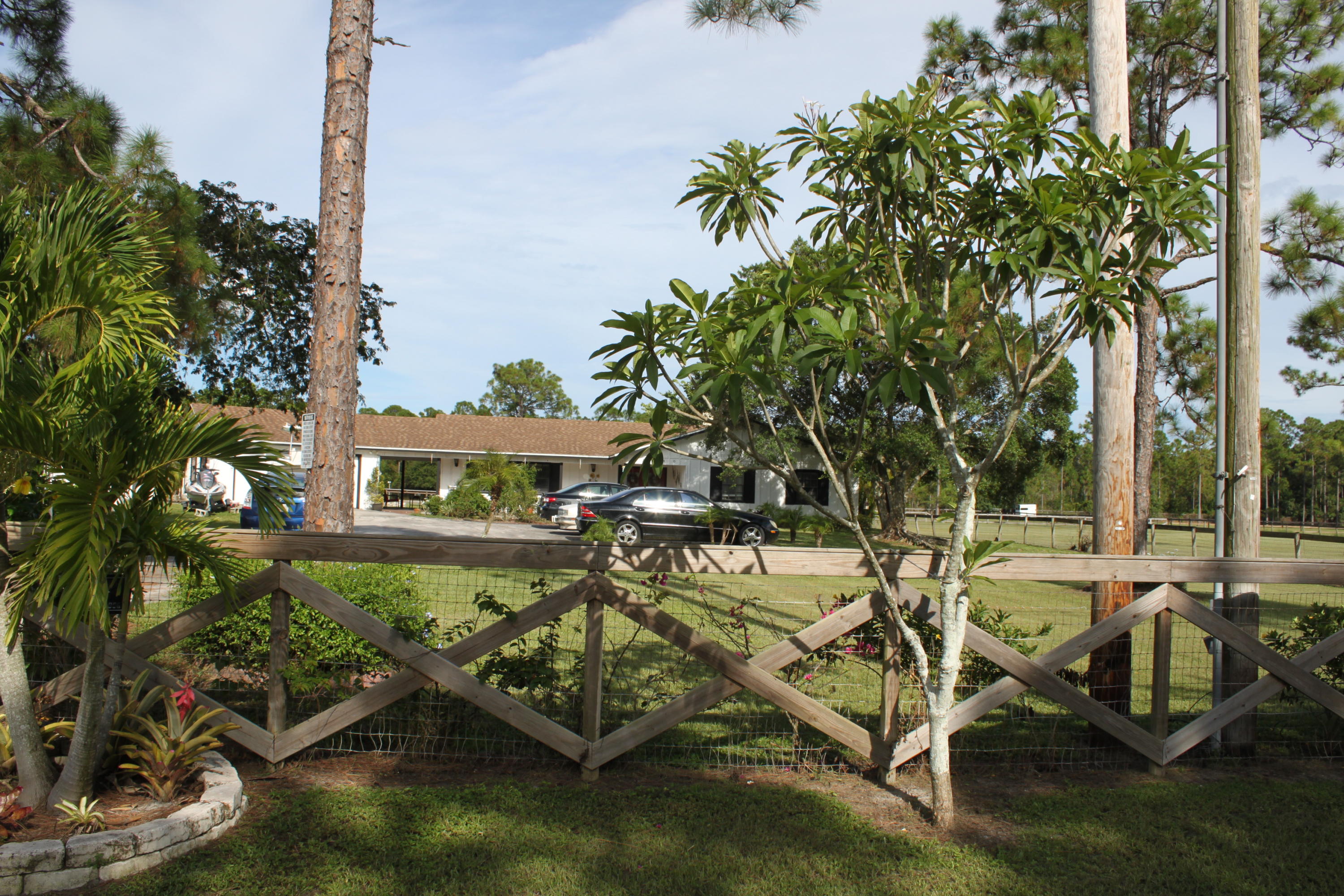 3840 Dellwood Road Loxahatchee, FL 33470 - Photo 24 of 60 a view of a swimming pool and lounge chairs