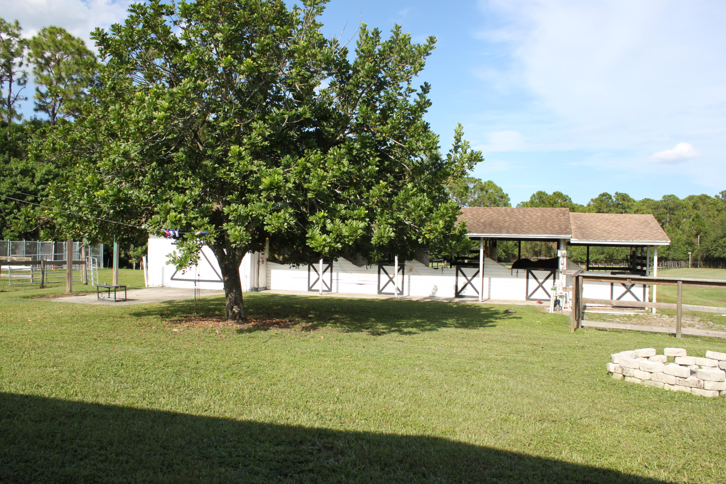 3840 Dellwood Road Loxahatchee, FL 33470 - Photo 25 of 60 a view of a swimming pool with an outdoor space and seating area