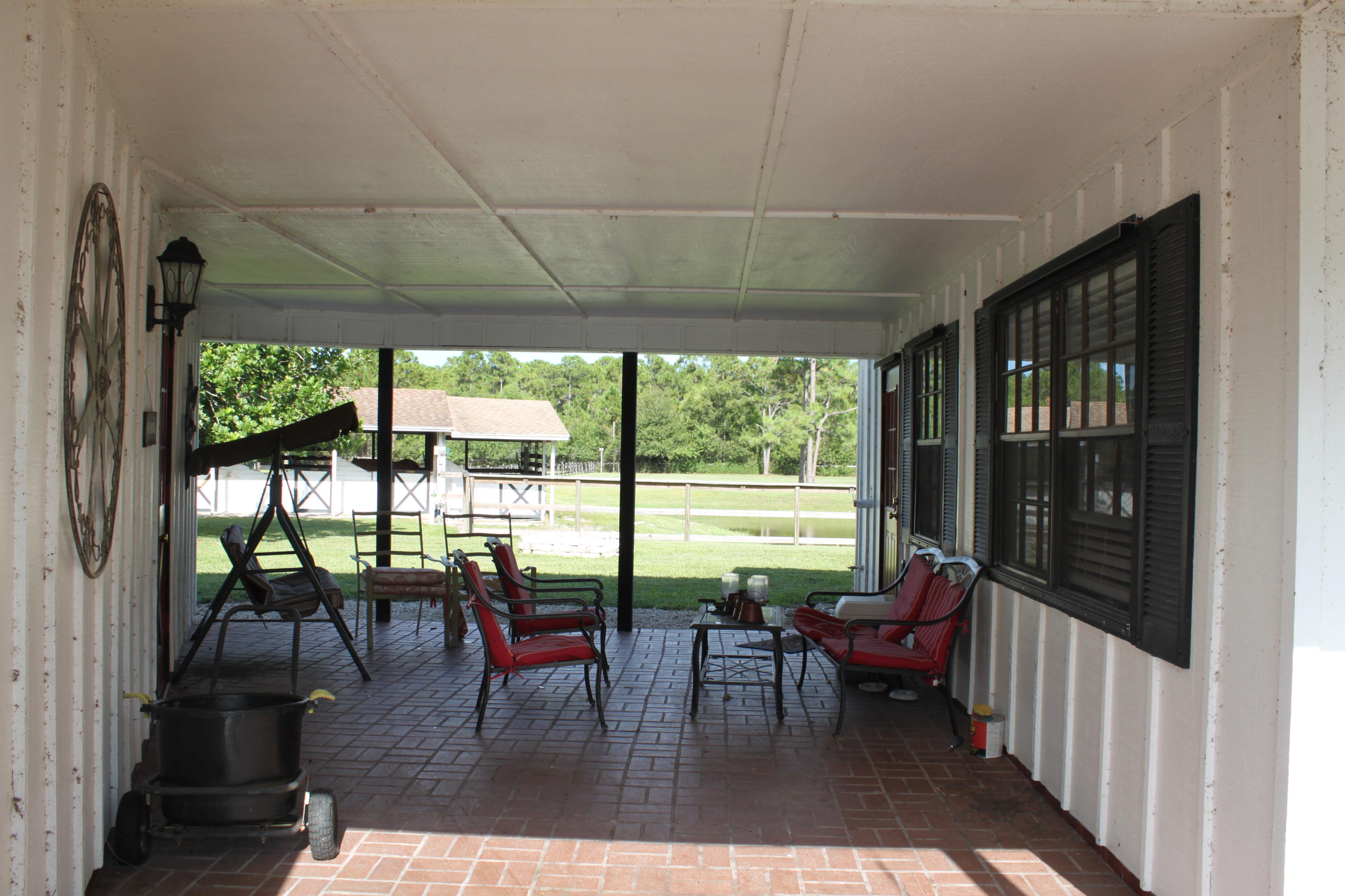 3840 Dellwood Road Loxahatchee, FL 33470 - Photo 29 of 60 a living room with furniture and a floor to ceiling window