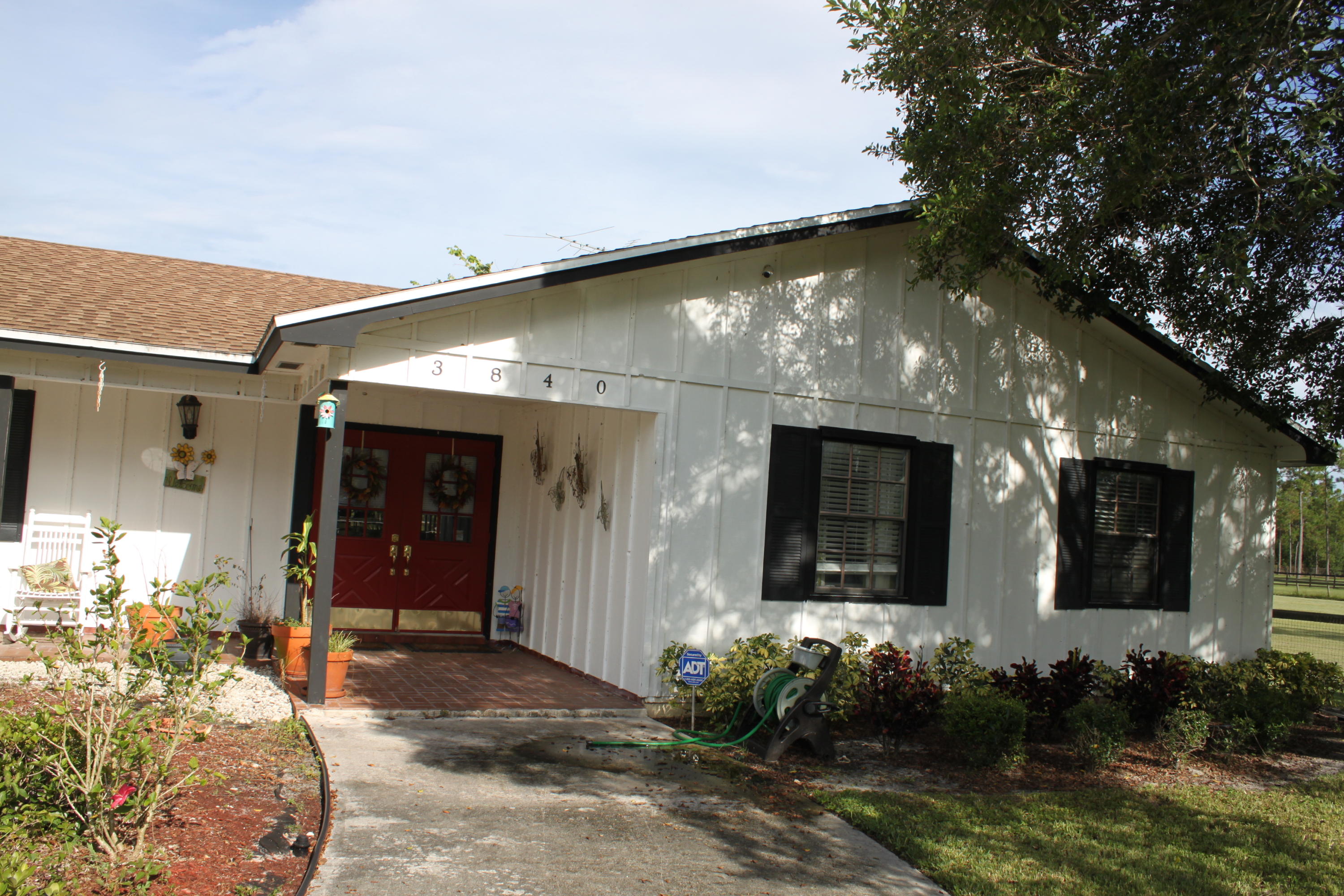 3840 Dellwood Road Loxahatchee, FL 33470 - Photo 3 of 60 a front view of a house