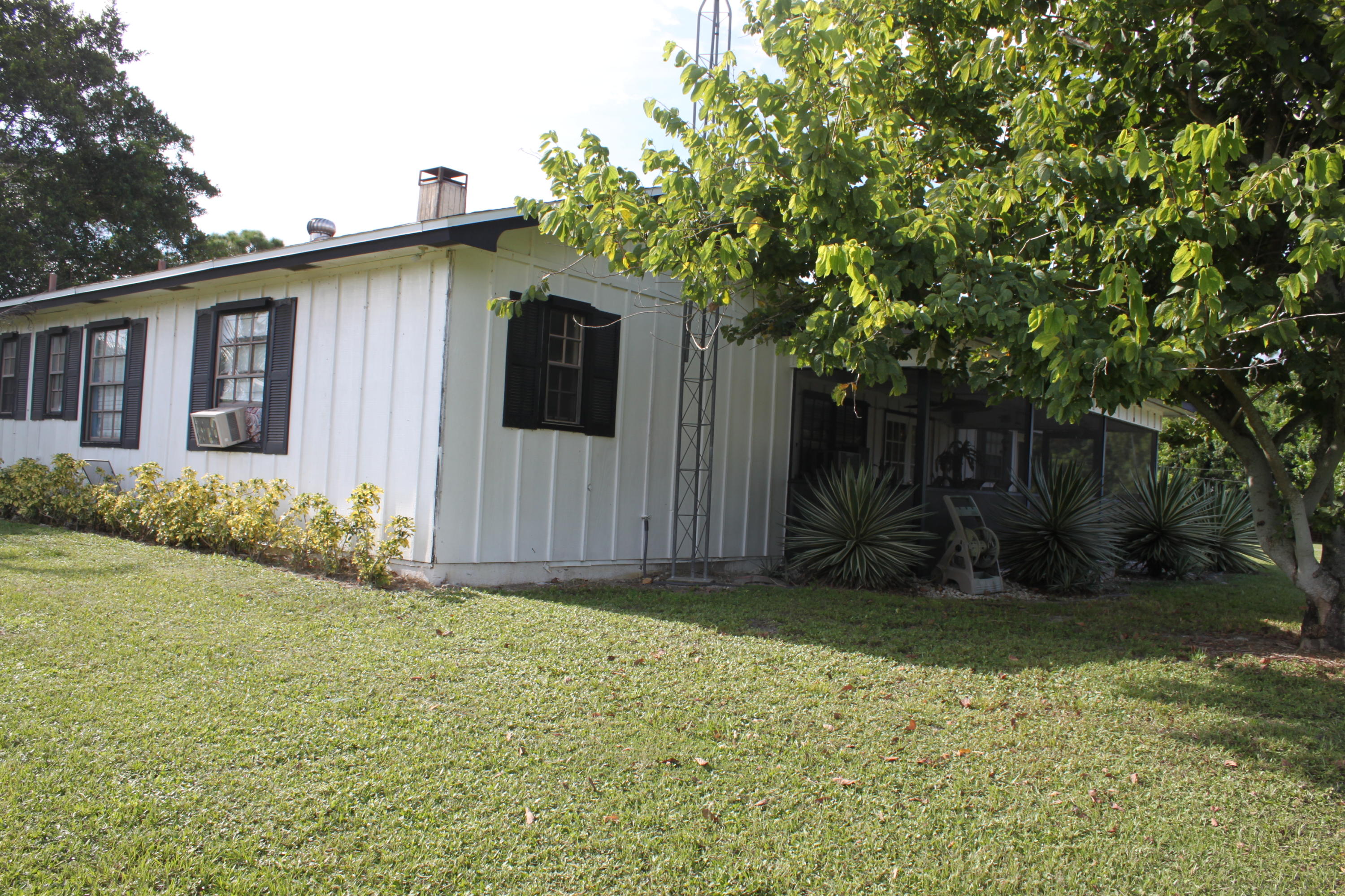 3840 Dellwood Road Loxahatchee, FL 33470 - Photo 35 of 60 a front view of a house with a yard