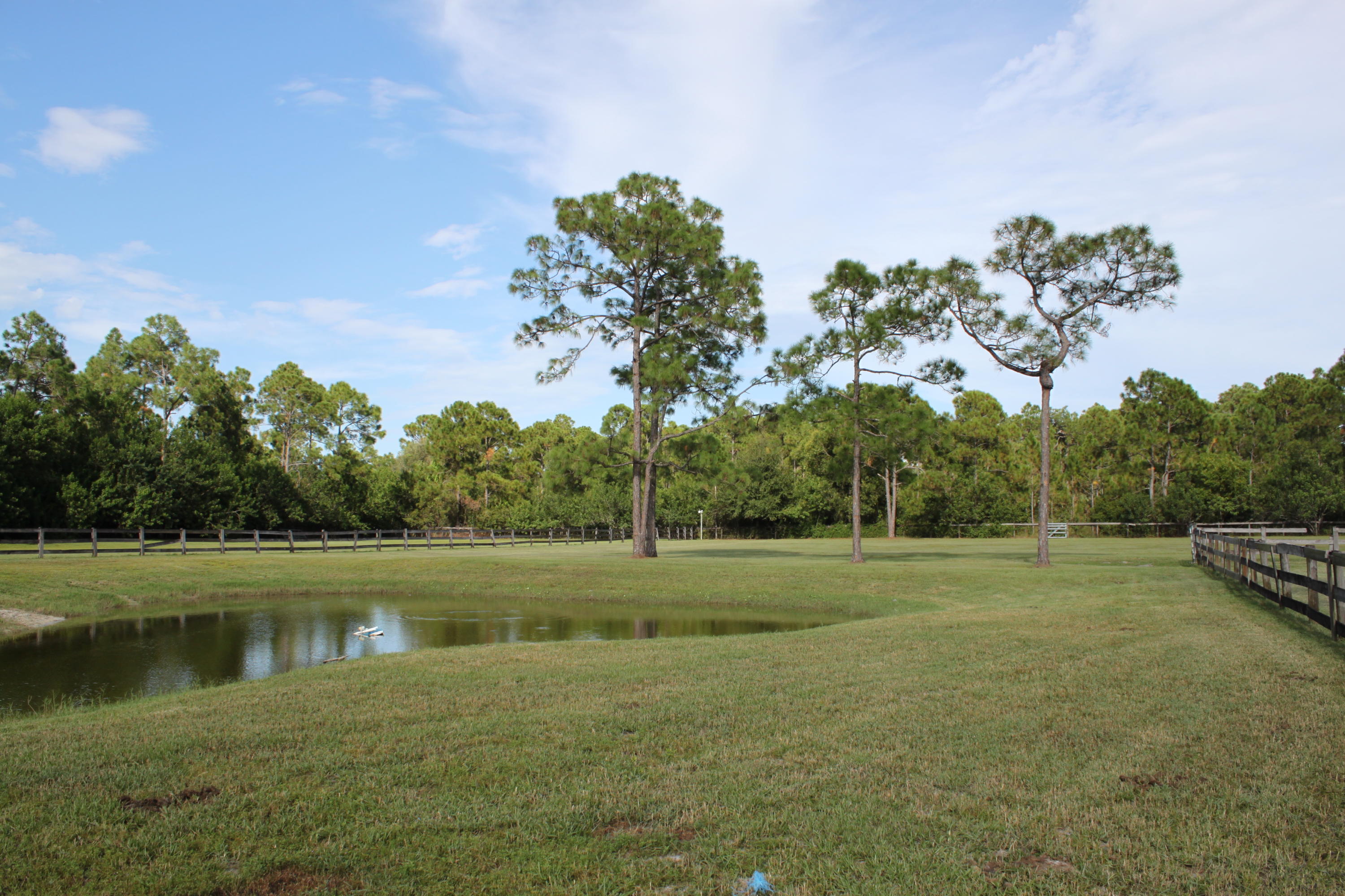 3840 Dellwood Road Loxahatchee, FL 33470 - Photo 37 of 60 a view of a golf course with a lake