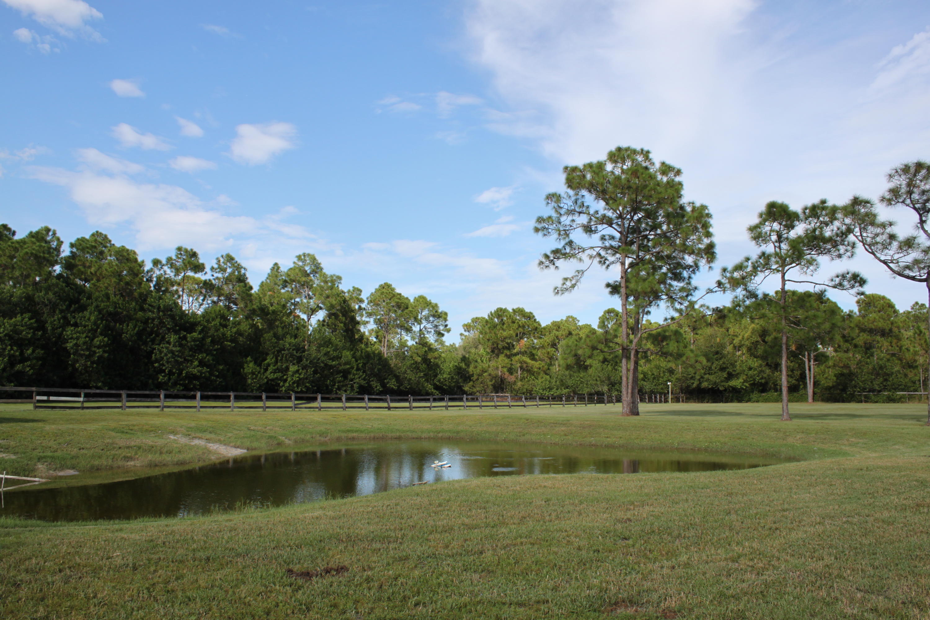 3840 Dellwood Road Loxahatchee, FL 33470 - Photo 38 of 60 a view of a golf course with a lake