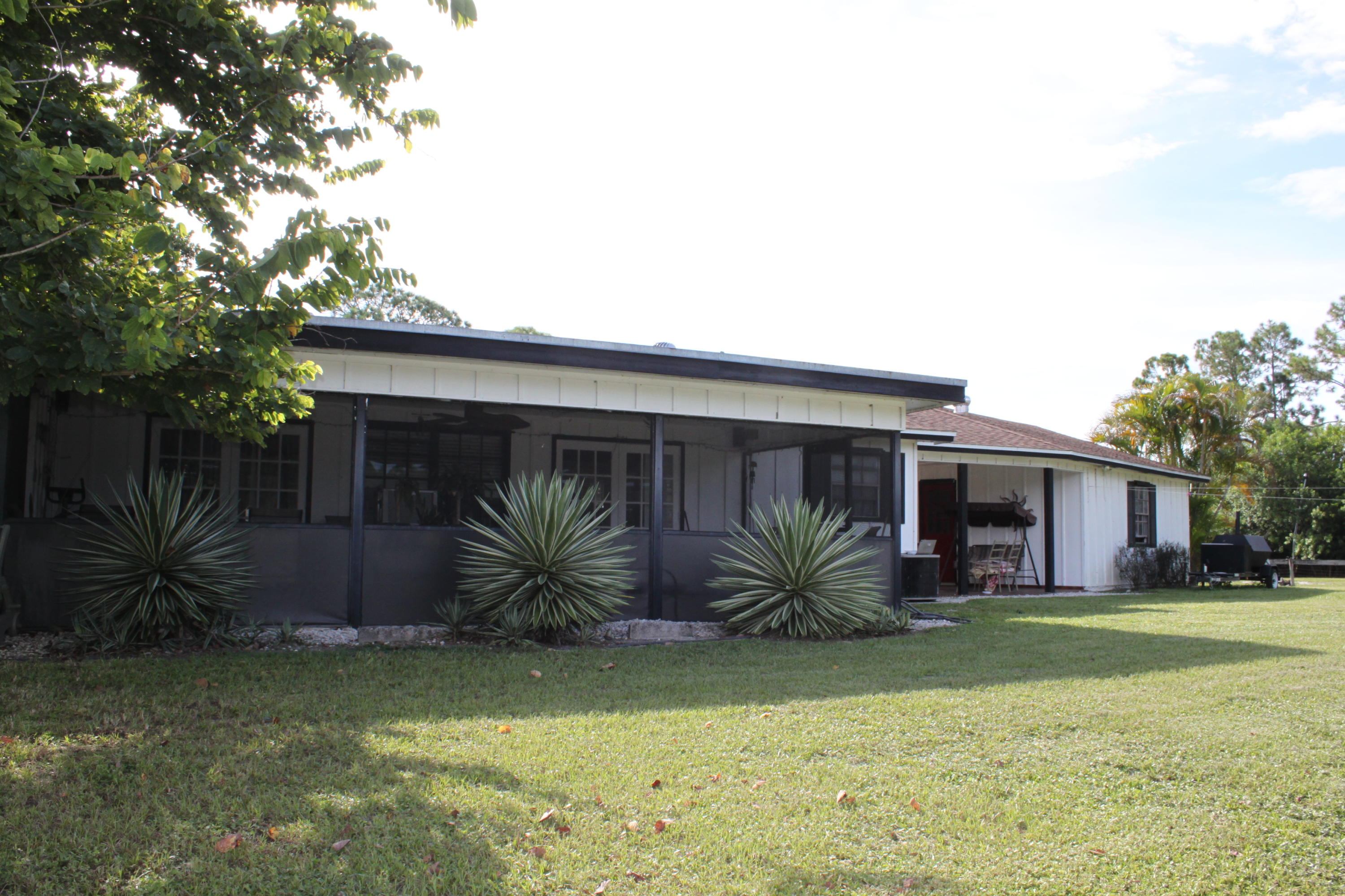3840 Dellwood Road Loxahatchee, FL 33470 - Photo 43 of 60 a house with a yard