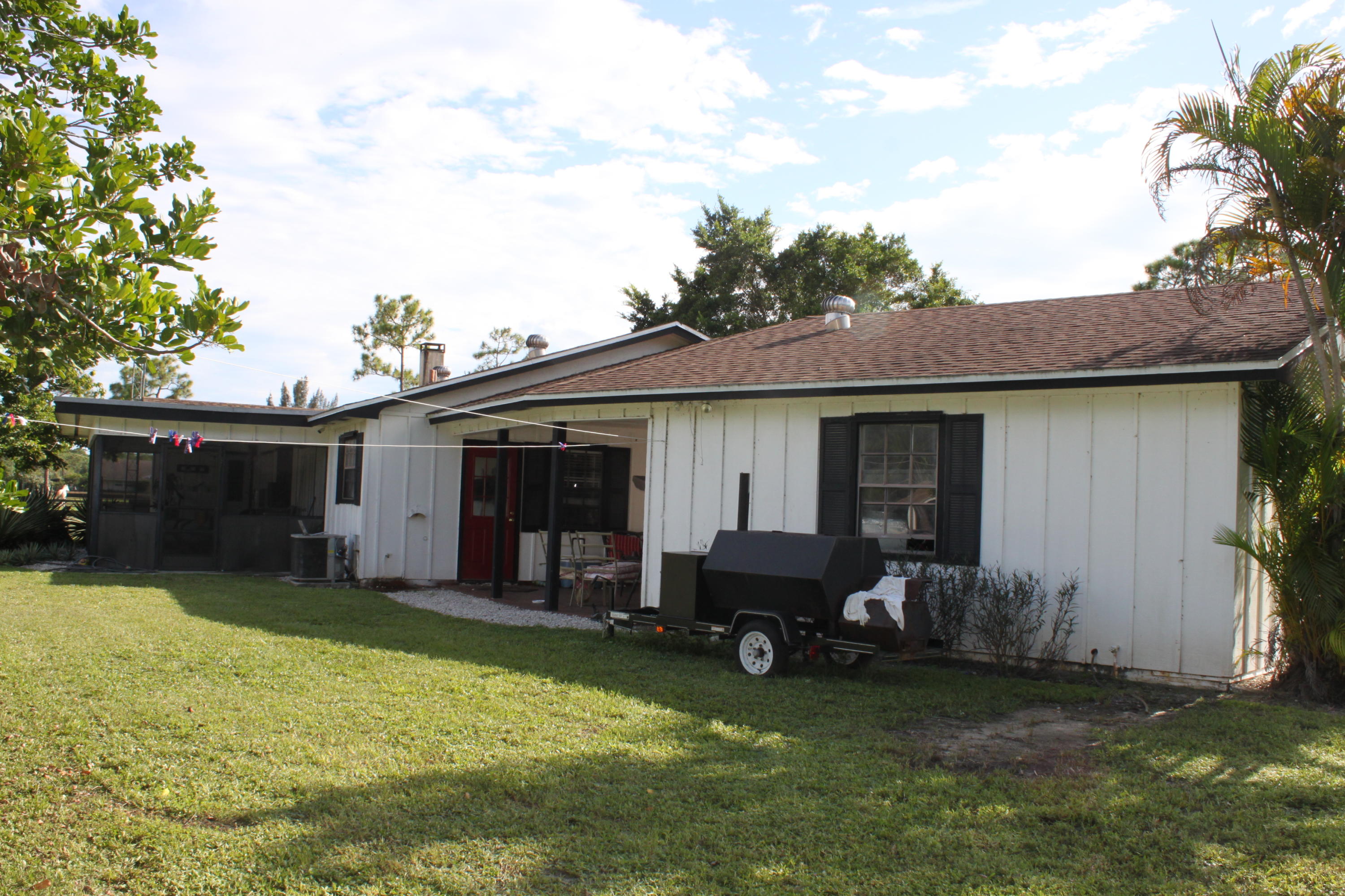 3840 Dellwood Road Loxahatchee, FL 33470 - Photo 49 of 60 a house view with a garden space
