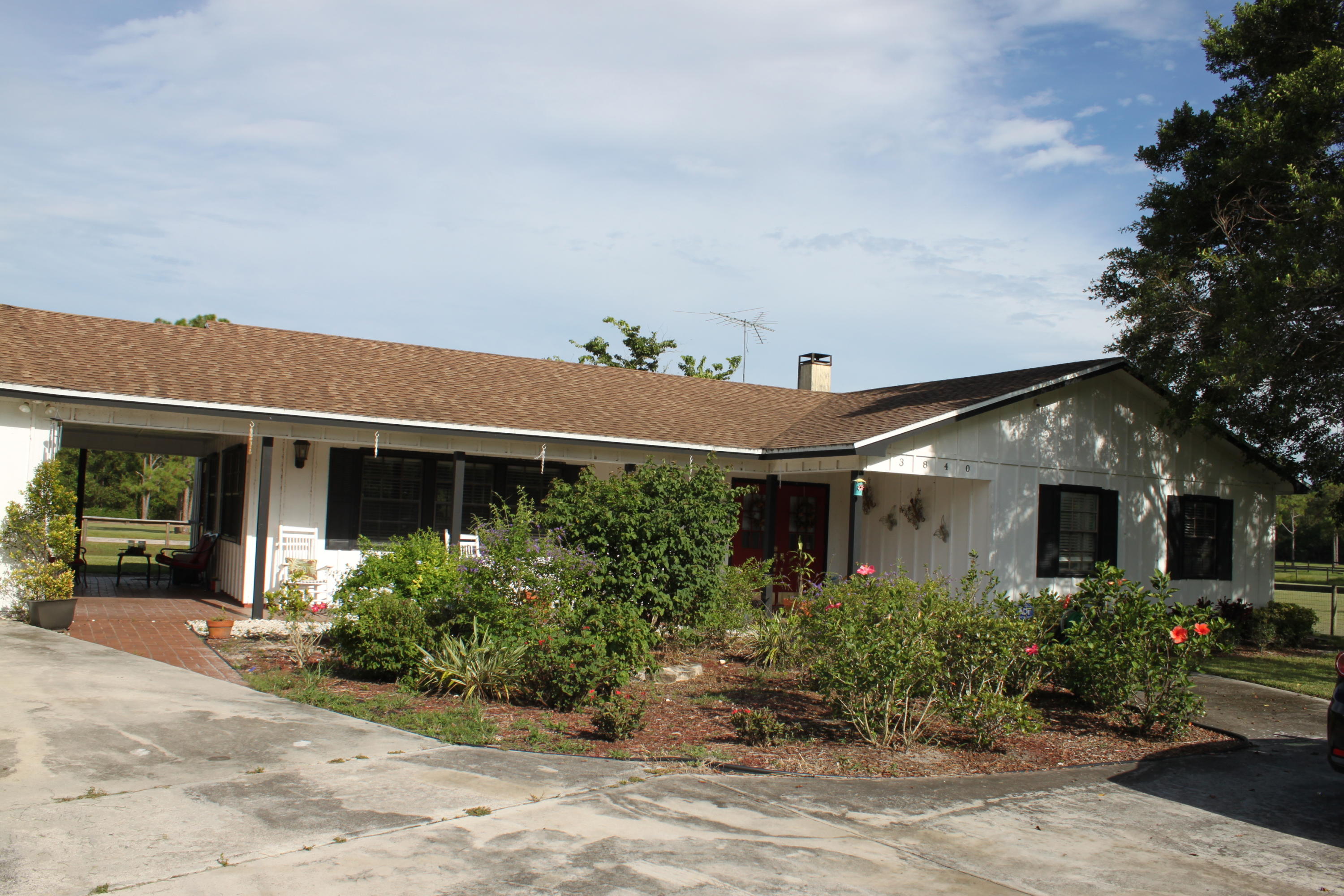 3840 Dellwood Road Loxahatchee, FL 33470 - Photo 6 of 60 a front view of a house with garden