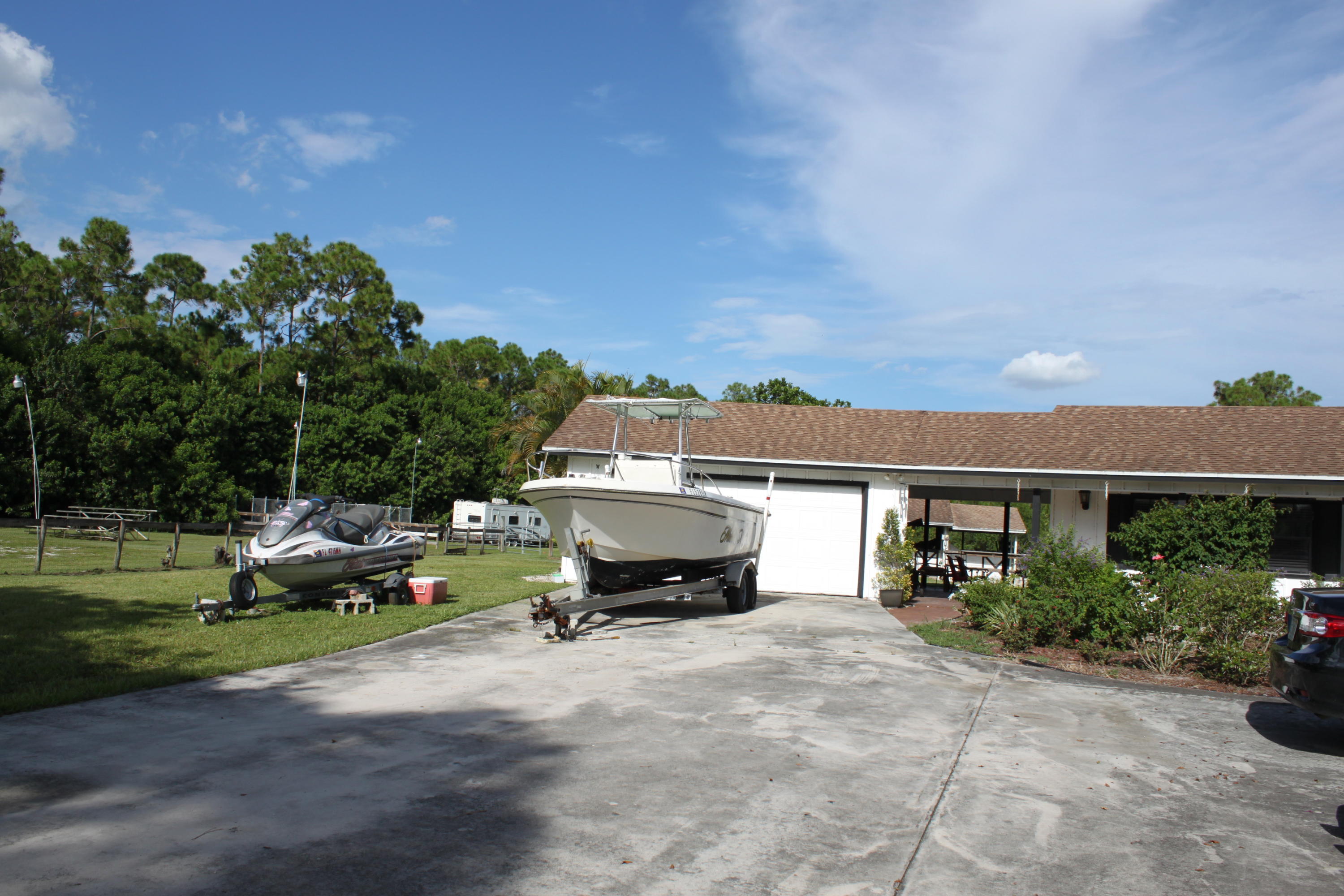 3840 Dellwood Road Loxahatchee, FL 33470 - Photo 10 of 60 a car parked in front of a house