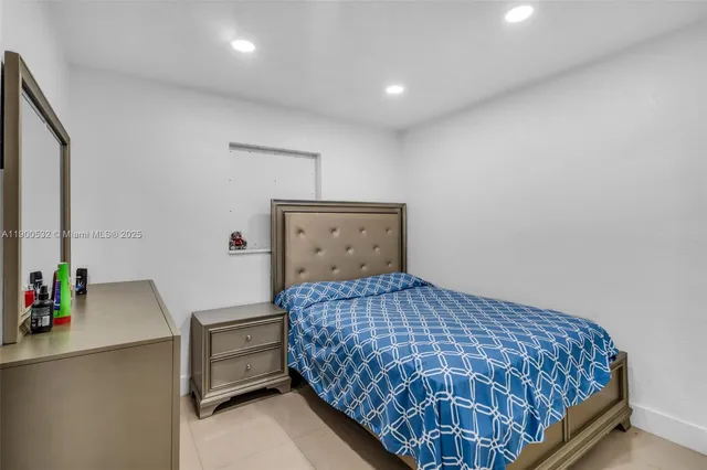 a bedroom with a bed and a desk