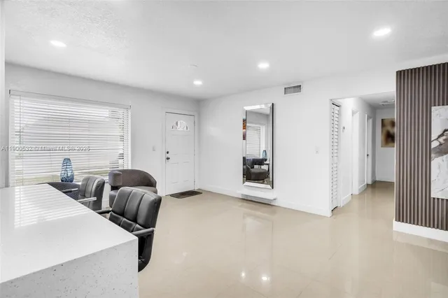 a view of a livingroom with furniture and a window