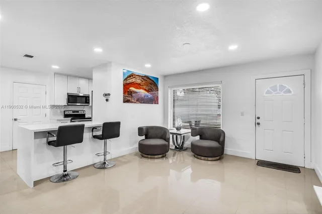 a livingroom with workspace and a couch