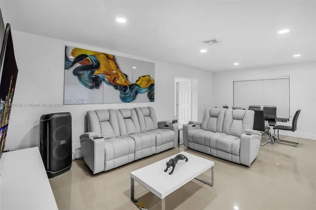 a living room with furniture and a rug