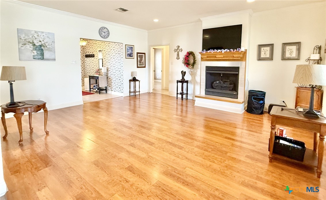 415 South Trinity Street Edna, TX 77957 - Photo 8 of 46 a living room with furniture a flat screen tv and a fireplace