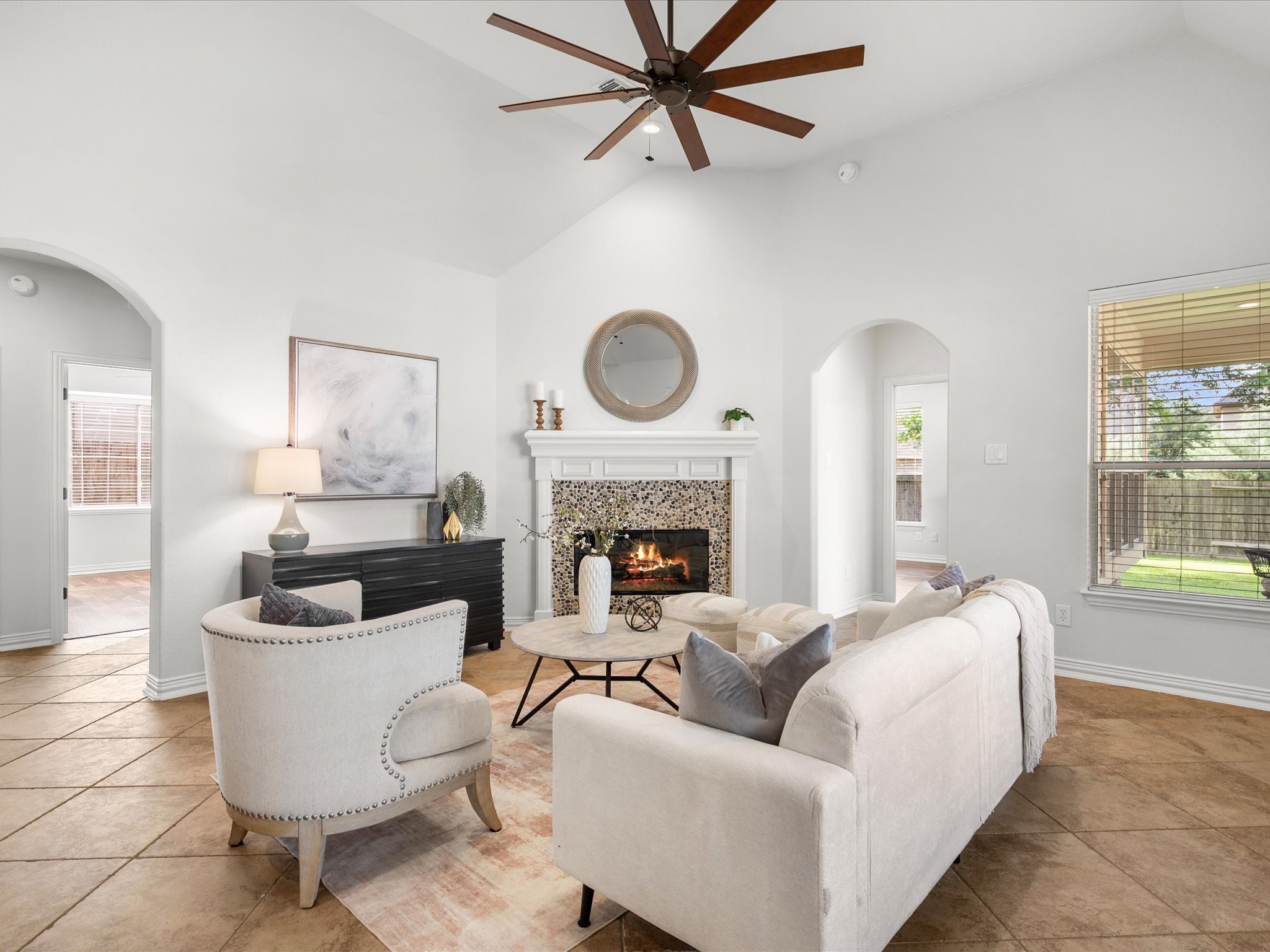 323 Arbor Ridge Lane Conroe, TX 77384 - Photo 14 of 40 Soaring ceilings, a wall of windows, and a fireplace that anchors the whole room. Cozy somehow still feels grand in here. Curl up and stay awhile.