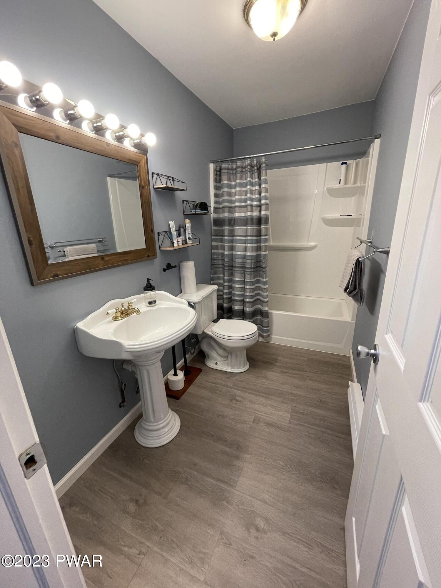 146 Roundhill Road Dingmans Ferry, PA 18328 - Photo 38 of 53 a bathroom with a sink toilet and shower