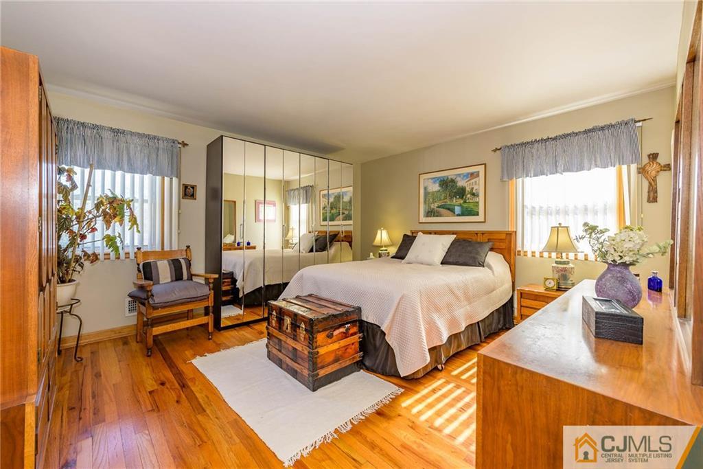 141 Devon Road Colonia, NJ 07067 - Photo 12 of 25 a spacious bedroom with a bed and wooden floor