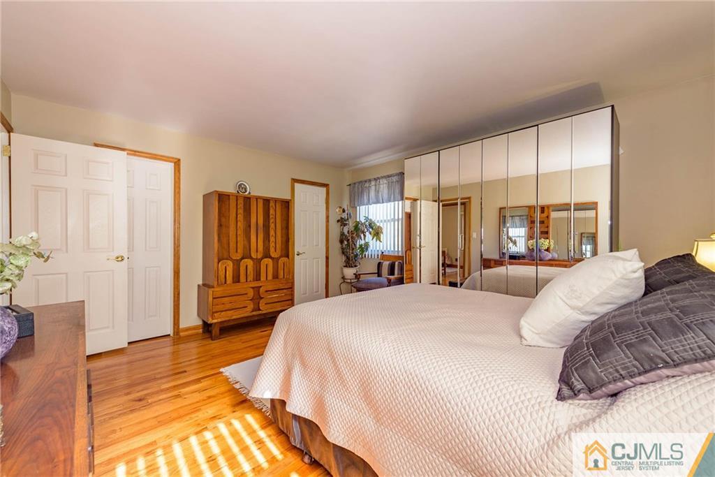 141 Devon Road Colonia, NJ 07067 - Photo 13 of 25 a bedroom with a bed and a walk in closet