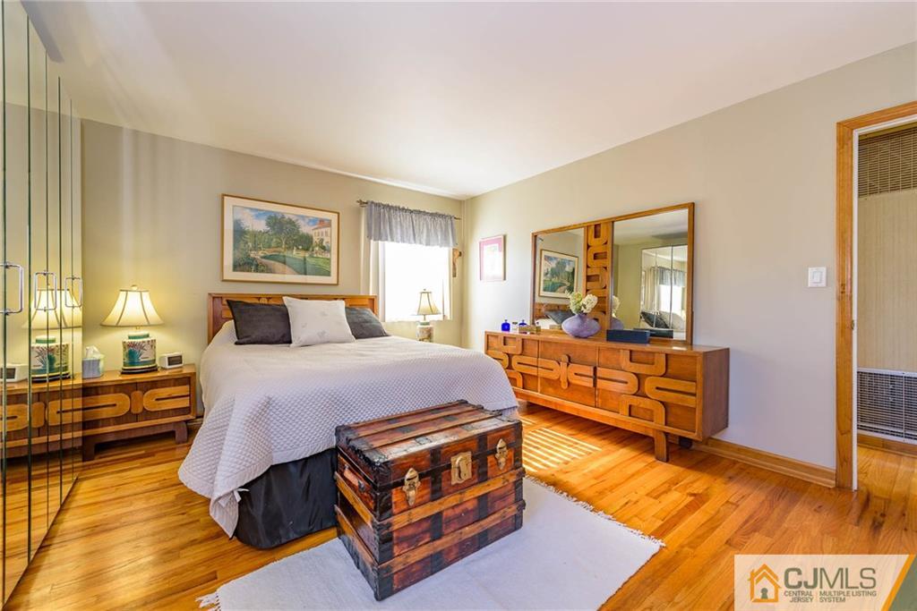 141 Devon Road Colonia, NJ 07067 - Photo 14 of 25 a bedroom with a bed and wooden floor