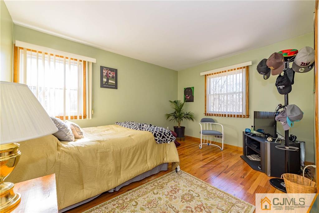 141 Devon Road Colonia, NJ 07067 - Photo 16 of 25 a bed sitting in a bedroom next to a window