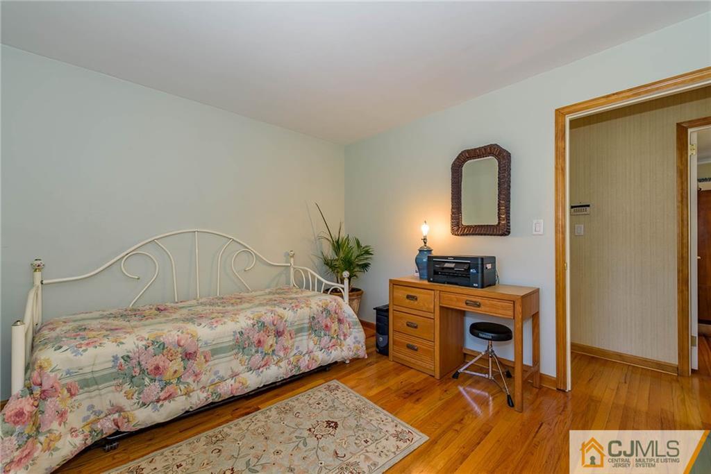 141 Devon Road Colonia, NJ 07067 - Photo 18 of 25 a bedroom with a bed and a table in it