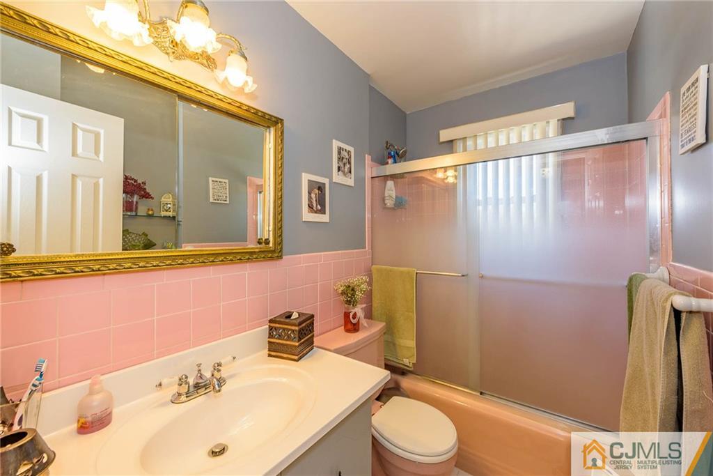 141 Devon Road Colonia, NJ 07067 - Photo 19 of 25 a bathroom with a sink mirror vanity and toilet