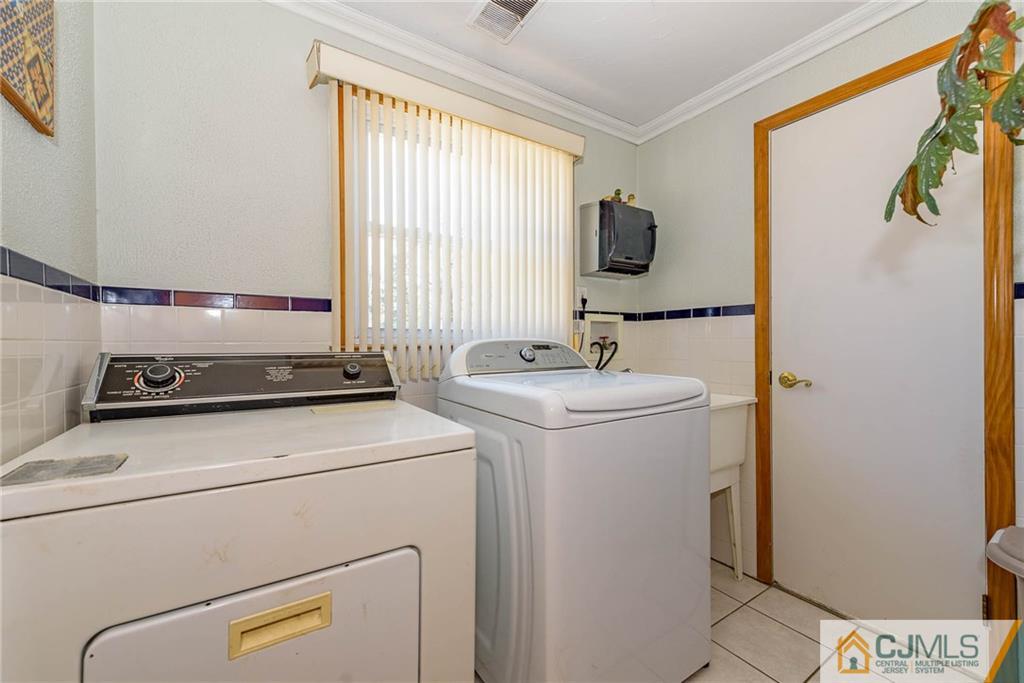 141 Devon Road Colonia, NJ 07067 - Photo 22 of 25 a utility room with dryer and washer