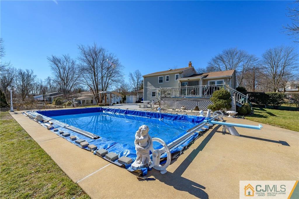 141 Devon Road Colonia, NJ 07067 - Photo 24 of 25 a swimming pool with outdoor seating and yard